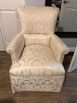 2 cream colored cushioned chairs