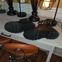 Women's black combat boots with accent chain