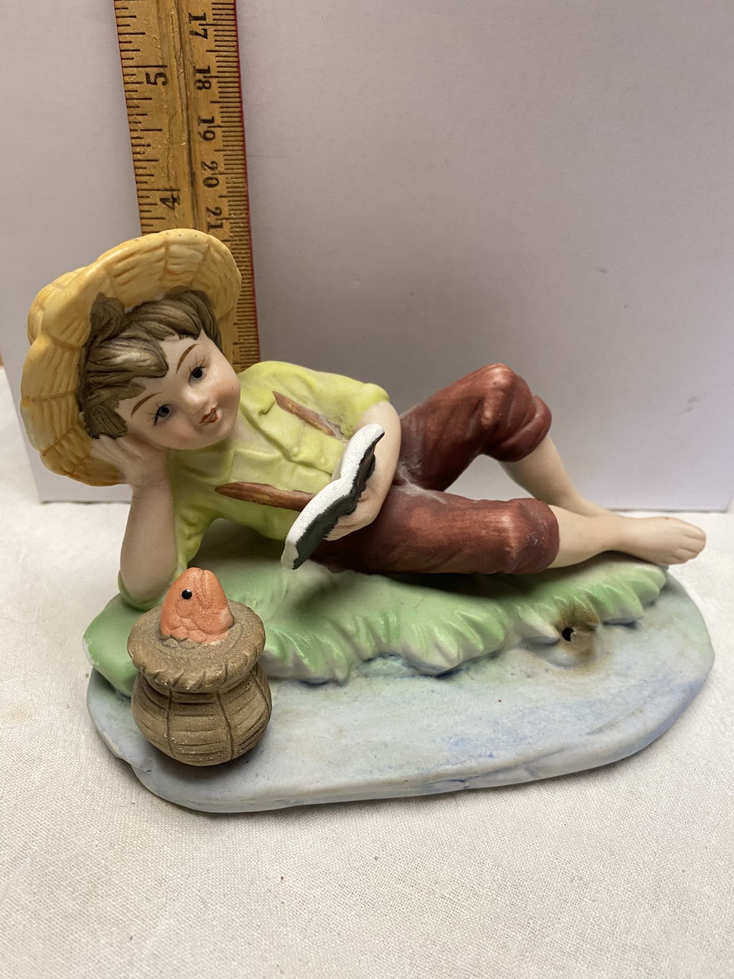 1061. Ceramic Boy Reading With Basket Of Fish Figurine Unknown Brand. $10.00