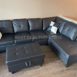 Black faux leather sectional couch with ottoman