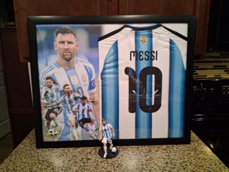 LIONEL MESSI OF THE MIAMI AFA SOCCER TEAM, BRANDED,AUTHENTIC FRAMED JERSEY WITH ACTION FIGURE.