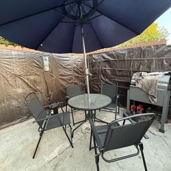 Patio table with umbrella and 4 chairs