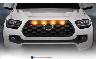 Black matte grill with raptor lights amber color