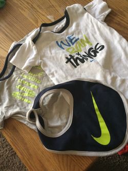Two Nike onesies and matching bib