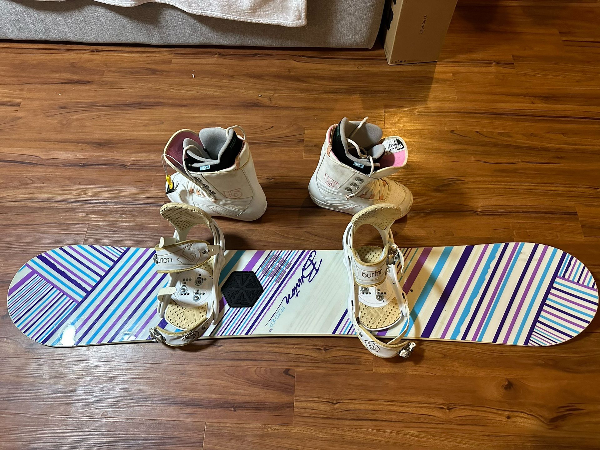 Used Burton Feather 53 woman’s snowboard with size 10 boots and bindings. 