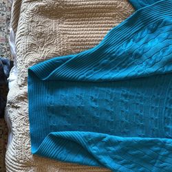 Ralph Lauren cable knit wrap-style cardigan. It features classic cable-knit and ribbed patterns with a draped, open-front design and long sleeves