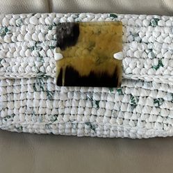 clutch, a handmade bag made from crocheted recycled plastic with a horn closure