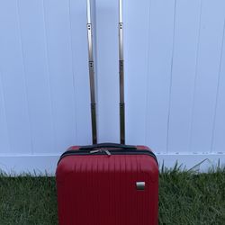 Small red hard shell carry-on rolling luggage