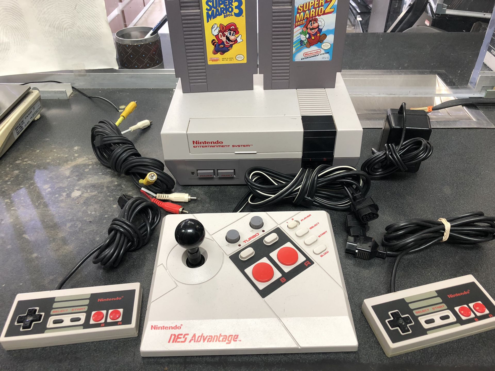 Nintendo nes-001 with 2 super Mario games 2 controllers and joystick controller
