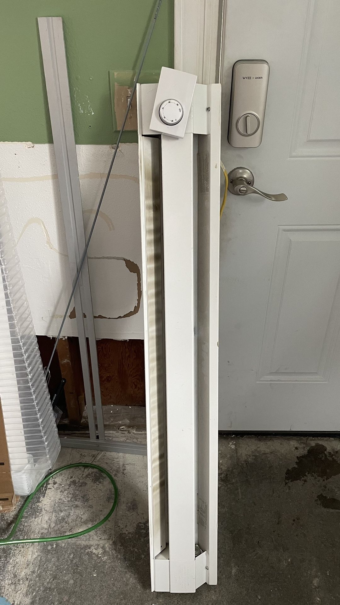 Baseboard Heater And Thermostat.