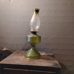 This vintage P&A Risdon / Eagle green glass pedestal oil lamp is a collectible item. 