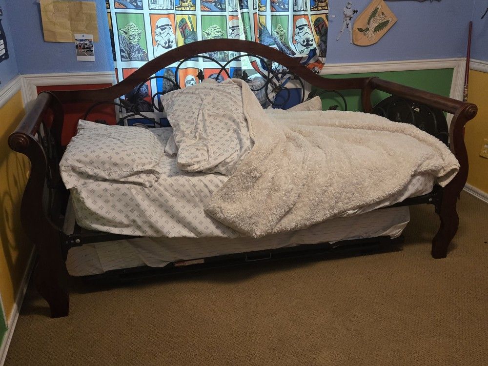 Solid WOOD AND black Iron DAYBED with TRUNDLE BED.