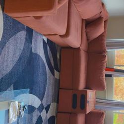 L-shaped couch with Bluetooth speakers attached