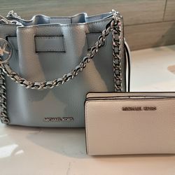 Michael Kors mini crossbody bag in a soft light blue pebbled leather and white pebbled wallet. 