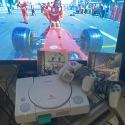 PlayStation one with two games and two controllers one memory card