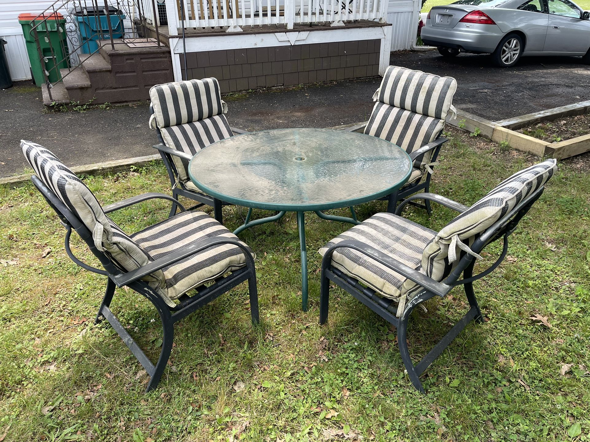 Outdoor Patio Set For Sale. Metal Chairs, Glass Table, and Cushions