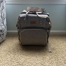 Diaper book bag with change table and pad