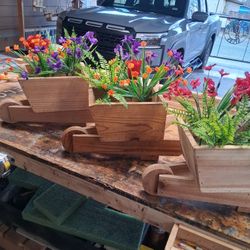 Wheelbarrow Planters $15 each With artificial Flower 