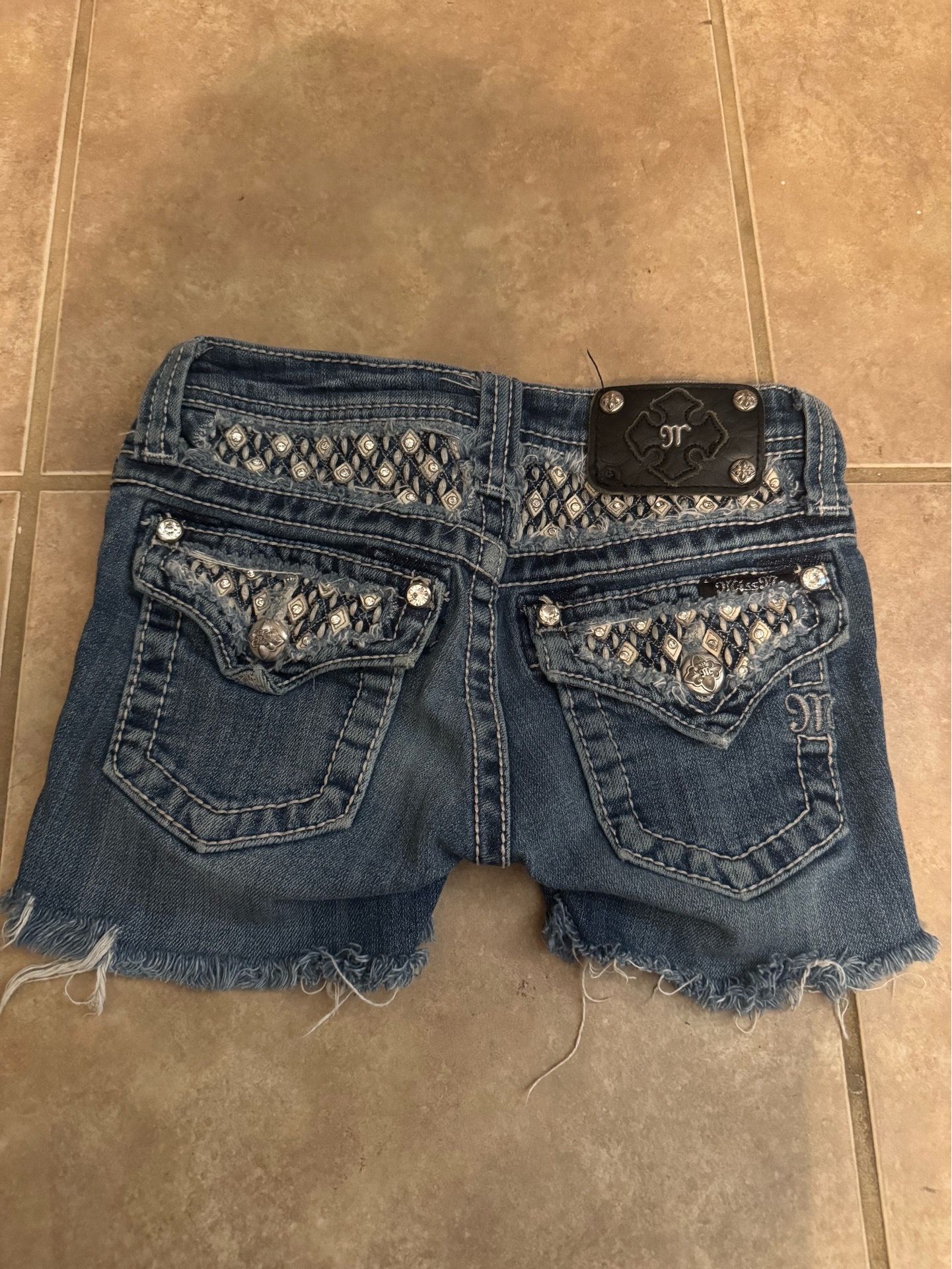 Navy blue Miss Me denim shorts with rhinestone heart patch and bedazzled details #y2kfashion #rhinestones