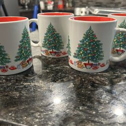 Set of four Christmas mugs.