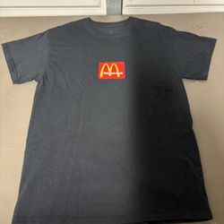 Travis Scott x McDonald's Cactus Jack Sesame T-Shirt in black with yellow graphic print