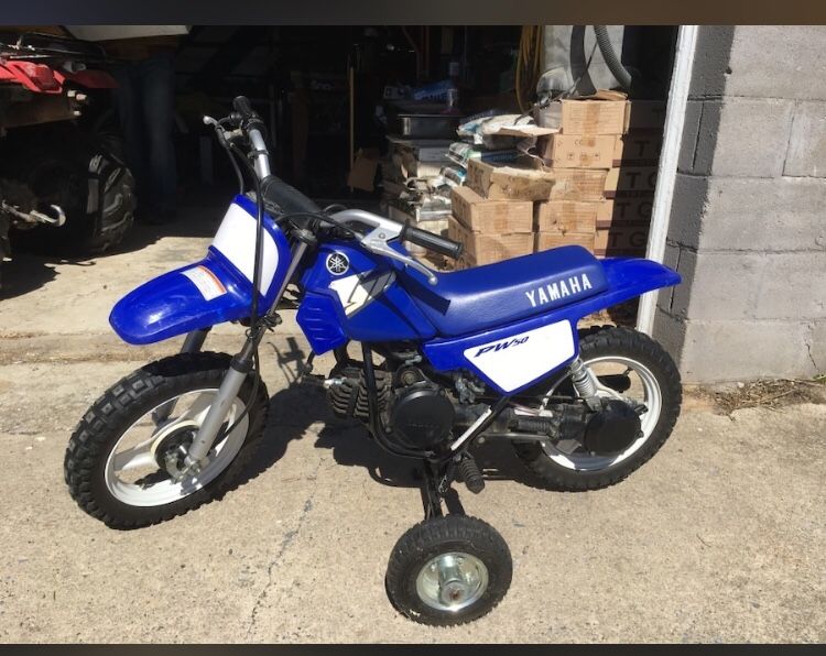 Yamaha PW 50. With training wheels. Training wheels included. May need carburetor cleaned. Some scratches and a 1” tear in seat.