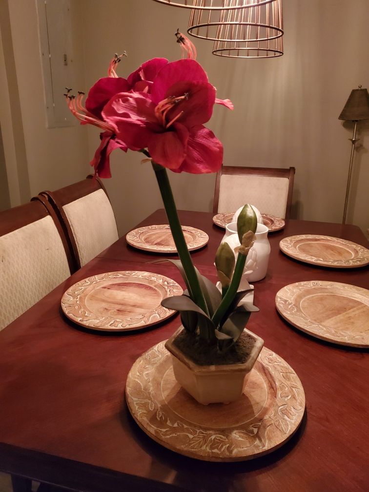 Red faux flower in a tan ceramic pot