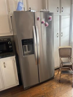 Whirlpool stainless steel side-by-side refrigerator with ice and water dispenser
