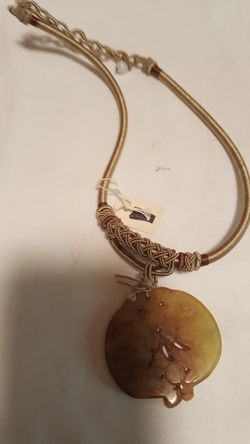 Carved pendant on twine/string necklace, unusual.