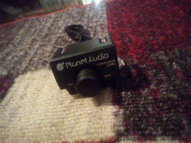 The device shown is a remote subwoofer level control for a Planet Audio car amplifier, likely part of their Anarchy series. It allows users to adjust&