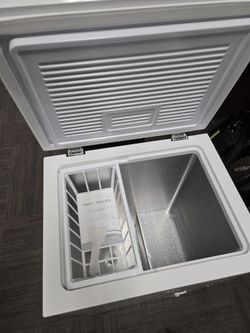 White Chest Freezer with Basket. a little damage on the bottom.