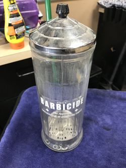 Used barbicide disinfectant container