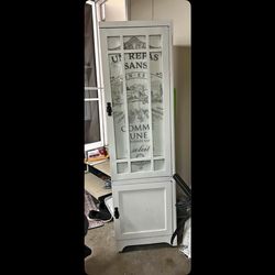 Solid Oak tall storage cabinet white has door 69 T—18.75D—19.75W all oak door opens to 4 shelf’s on bottom has storage