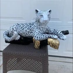 Snow Leopard On The Log Statue
