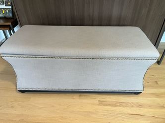 Upholstered storage bench with brass detailing