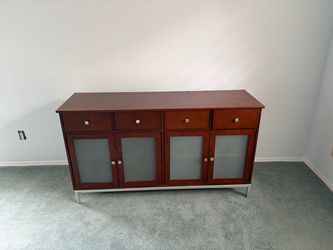 2 person couch, small table and medium sized dresser.
