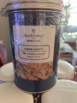 Magnolia Table almond biscotti comes in a reusable blue tin with a white lid.