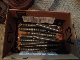 Springs for doors or lawn mowers