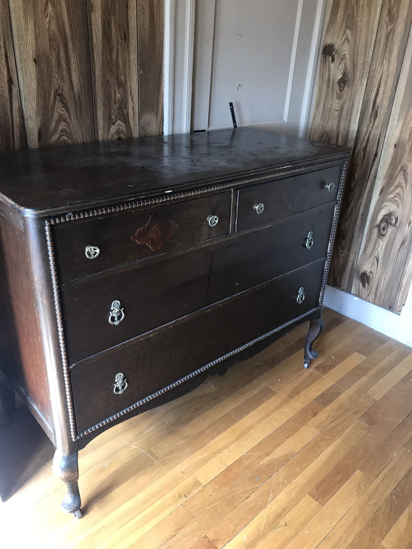 Antique dresser. Not sure of year. All drawers work. The mirror has a small piece missing on wooden spool. Must move on own on second floor.