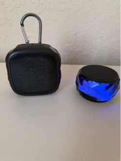 Set of Two Wireless Speakers, One Changes Colors, Needs the Adapter to Charge