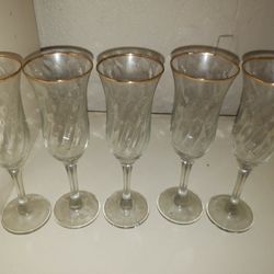 5 gold rimmed champagne glasses