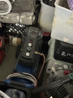 Garage full of equipment and car parts and etc.