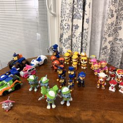 Large lot of  Paw Patrol toys, including various action figures and vehicles