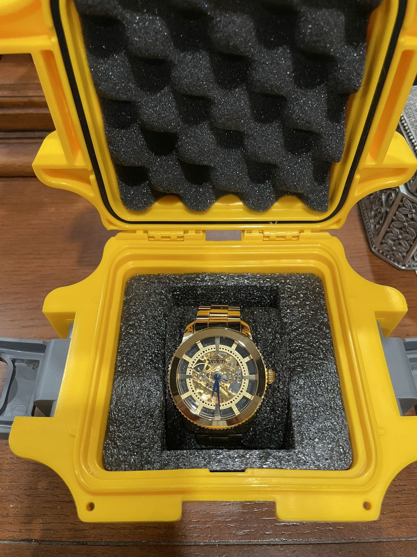 Invicta Objet D'Art or Vintage men's automatic gold tone stainless steel watch with a skeleton dial and blue hands.