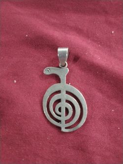 Reiki Choku Rei Pendant in Sterling Silver with some kind of clear stone set in it.