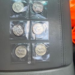 Six Kennedy half dollars three 1964 two 1967 and one 1968