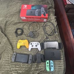 nintendo switch with two controllers two new joysticks and a case