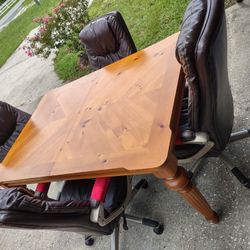 TABLE AND 4 PADDED ROLLER CHAIRS 