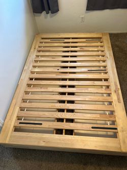 Queen size bed frame with four built in drawers.