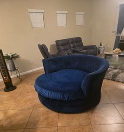 Blue Velvet sectional couches and a matching Oversized Swivel round chair